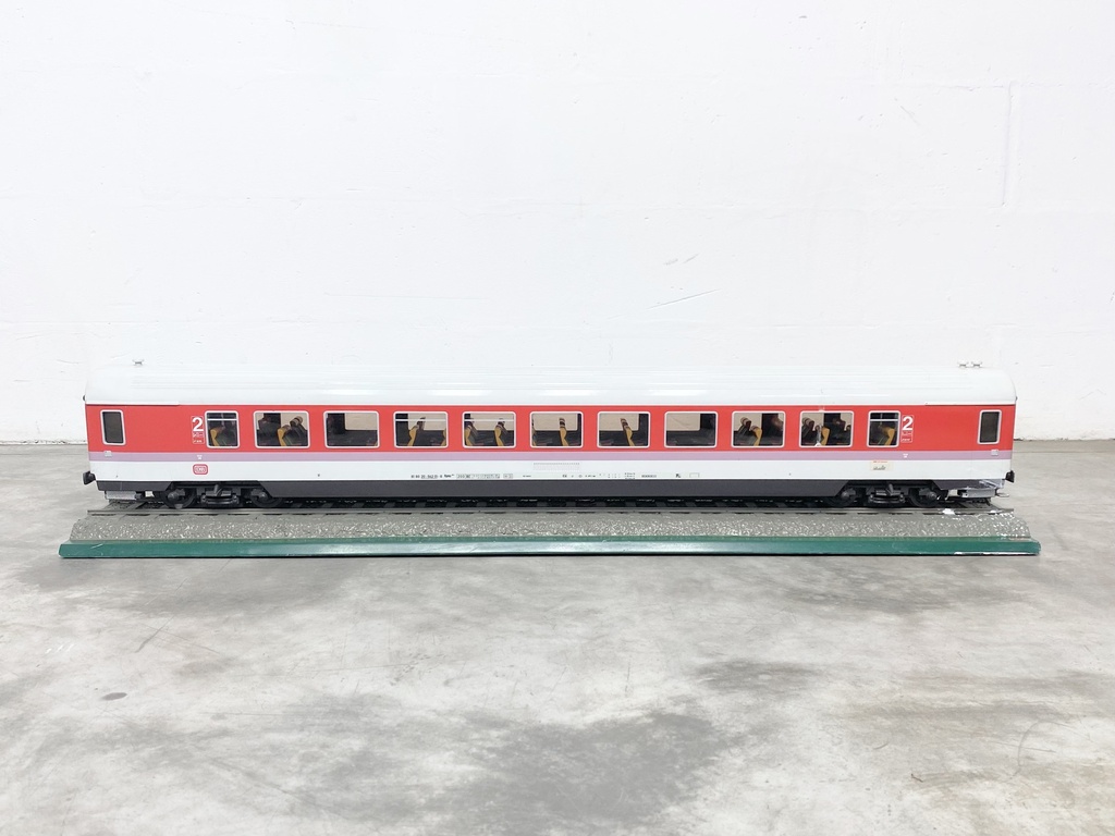 Red and White Model Train Passenger Car on Display Track