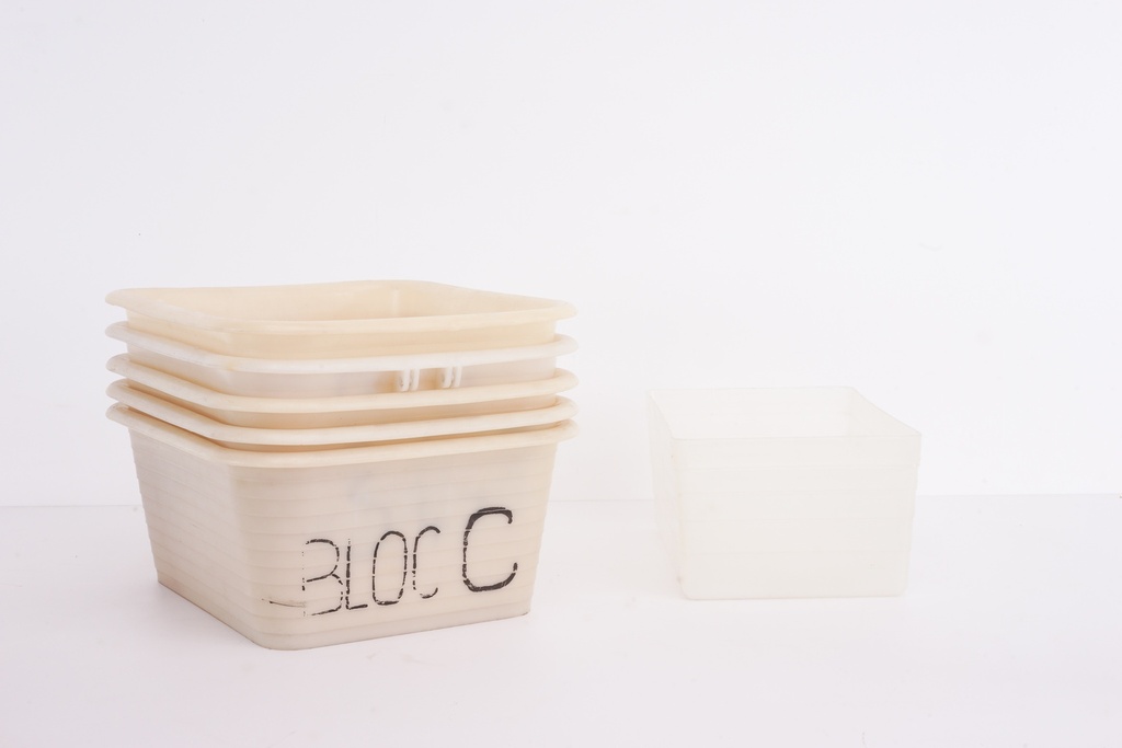 Stacked Cream Storage Bins with "Bloc C" Labeling