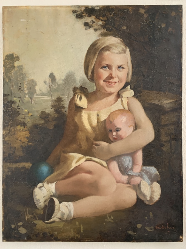 Child in Yellow Dress Holding a Doll Outdoors