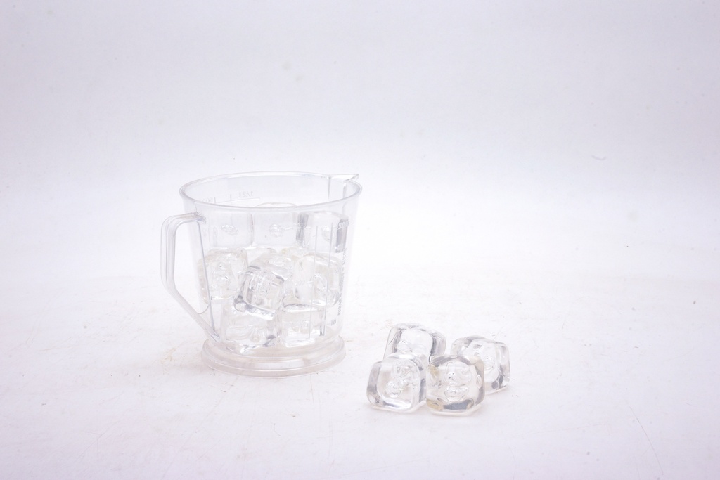 Clear Plastic Measuring Cup with Loose Ice Cubes
